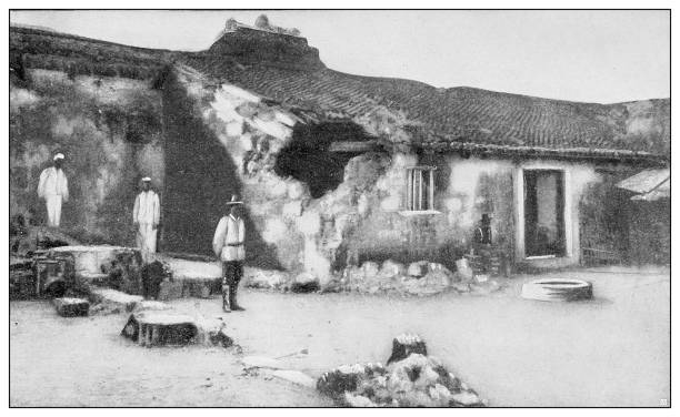 Antique black and white photograph of people from islands in the Caribbean and in the Pacific Ocean; Cuba, Hawaii, Philippines and others: Bombed Spanish fortification in Cavite, Philippines