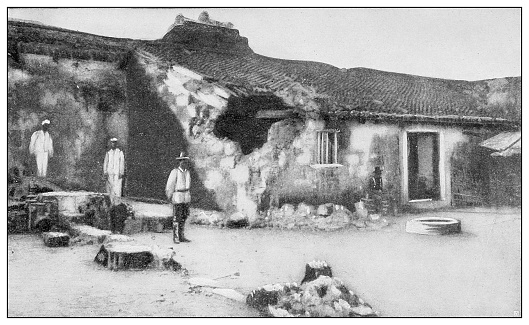 Antique black and white photograph of people from islands in the Caribbean and in the Pacific Ocean; Cuba, Hawaii, Philippines and others: Bombed Spanish fortification in Cavite, Philippines