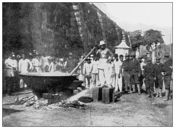 Antique black and white photograph: Sugar factory, Luzon, Philippines Antique black and white photograph of people from islands in the Caribbean and in the Pacific Ocean; Cuba, Hawaii, Philippines and others: Sugar factory, Luzon, Philippines filipino ethnicity stock illustrations