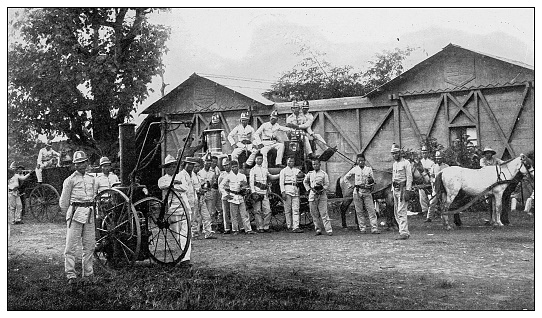 Antique black and white photograph of people from islands in the Caribbean and in the Pacific Ocean; Cuba, Hawaii, Philippines and others: Bamberos or Manila Fire Company, Philippines