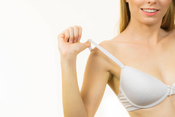 istock Young woman holding bra strap 1330230669