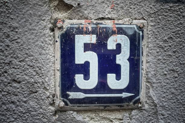 istock Old rusty metal sign with number 53 hung on a brick wall 1330233221