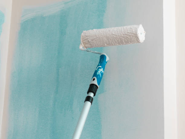 istock Person applying paint on wall 1330234636