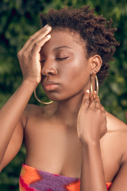 istock Dark skinned woman with closed eyes in spa salon 1330238026