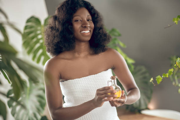 istock Woman with toothy smile showing scent 1330238078