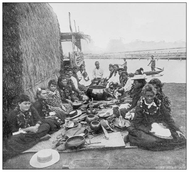Antique black and white photograph of people from islands in the Caribbean and in the Pacific Ocean; Cuba, Hawaii, Philippines and others: Grass hut and native 