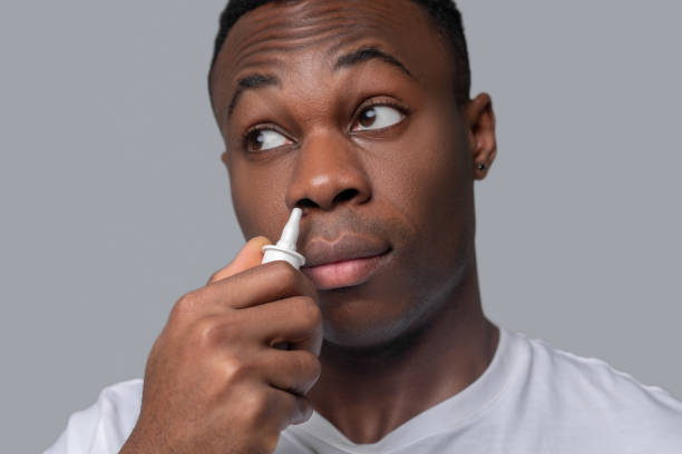 istock A dark-skinned man dropping drops to his nose 1330240326