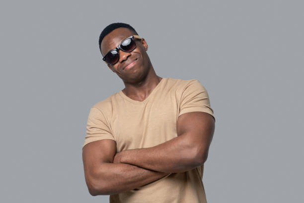istock Dark-skinned young man in beige tshirt looking determined 1330240396
