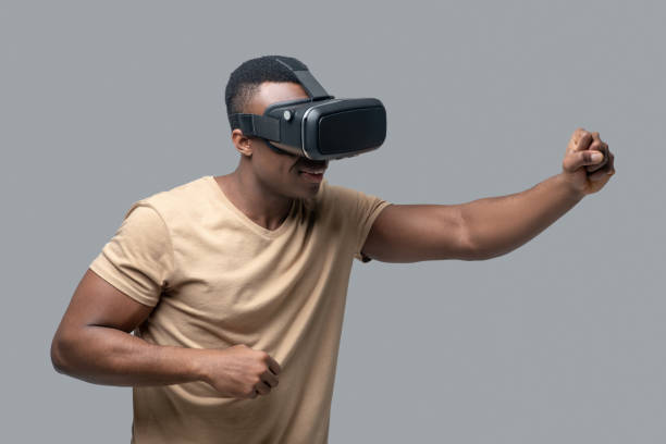 istock African american young man in vr glasses looking involved 1330240411