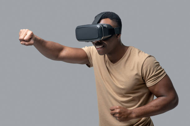 istock African american young man in vr glasses looking involved 1330240413