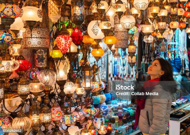 Smiling Young Woman Looking At Turkish Lamps For Sale In The Grand Bazaar Istanbul Turkey Stock Photo - Download Image Now