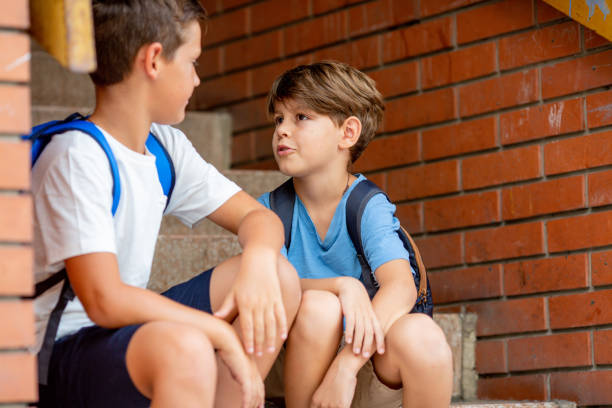 istock Sitting in front of school. 1330242466