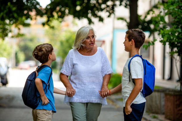 istock Grandmother is taking her grandsons to school. 1330242559