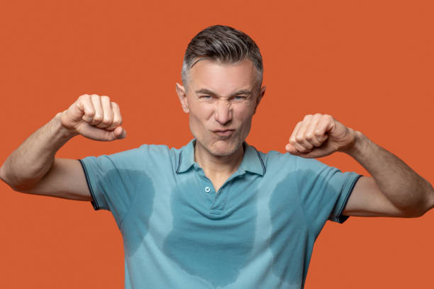 istock Displeased man with grimace in wet tshirt 1330244845