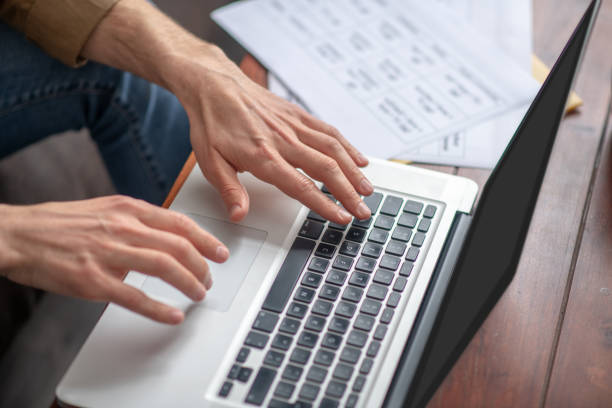 istock Male hands over laptop keyboard writing 1330244927