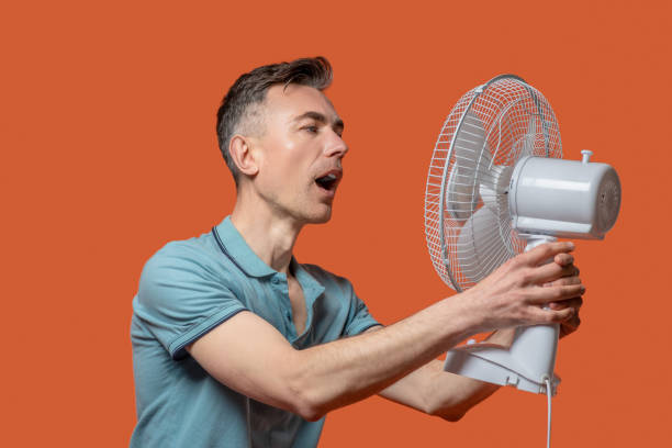 istock Man with open mouth in front of ventilator 1330244997