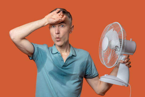 istock Unhappy man in wet tshirt touching forehead 1330245001