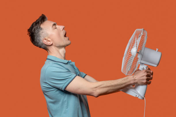 istock Profile of man holding fan in his hands 1330245004