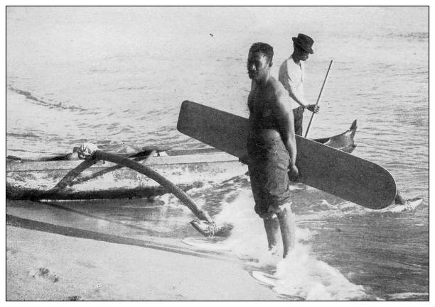 Antique black and white photograph: Surf board, Hawaii, 1898 Antique black and white photograph of people from islands in the Caribbean and in the Pacific Ocean; Cuba, Hawaii, Philippines and others: Surf board, Hawaii, 1898 beach holiday photos stock illustrations