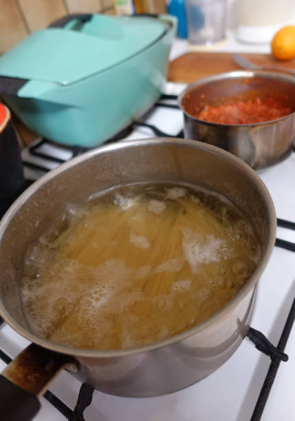 istock Spaghetti and Bolognese sauce being cooked in saucepans 1330247160
