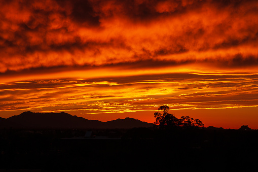 Estrella Mountain and downtown Phoenix, AZ under a rare cloudy red sunset
