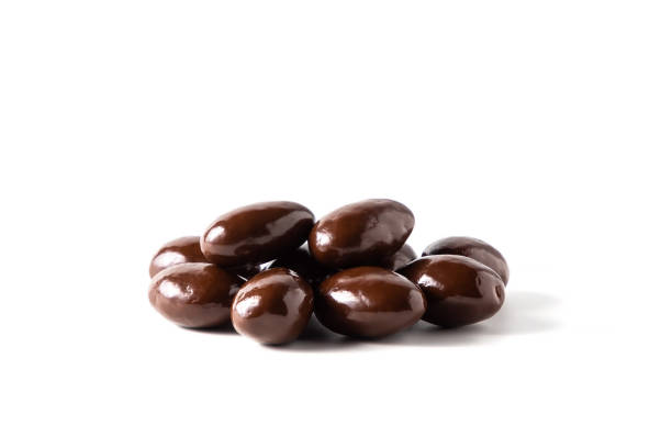 istock Dark chocolate covered almonds, chocolate dragee on white background 1330254731