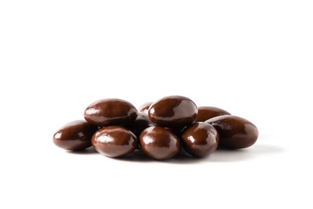 istock Dark chocolate covered almonds, chocolate dragees on white background , isolated 1330254734