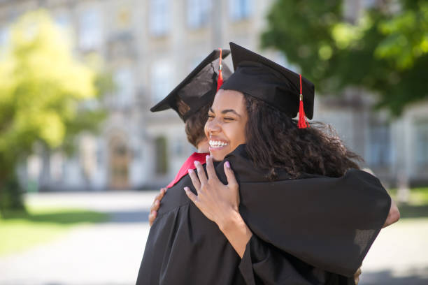 istock Friends hugging each other after graduation and feeling happy 1330256761