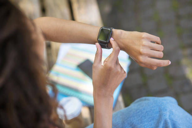 istock A girl with a smartwatch on her wrist 1330256925