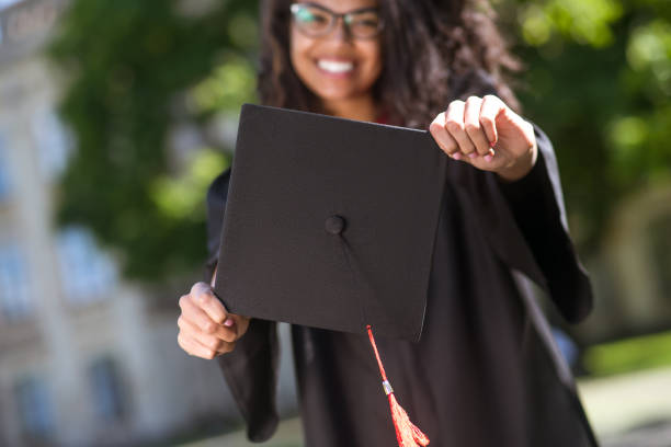 istock Dark-haired graduate feeling happy and excited about graduation 1330256981
