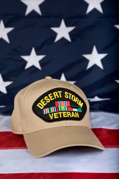 istock Desert Storm Veterans cap vertical close up with American Flag background 1330257184