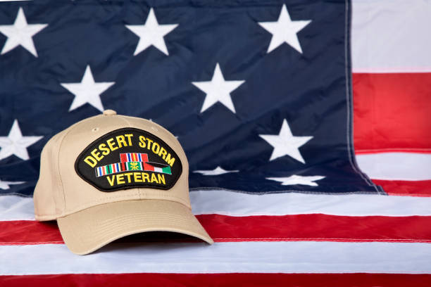 Desert Storm Veterans cap close up with American Flag background Desert Storm Veterans cap {AKA; Gulf War) inscribed with text depicting the war from January 17, 1991 – February 28, 1991. 1991 stock pictures, royalty-free photos & images