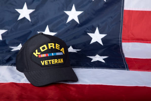 istock Korea Veterans cap with American Flag background 1330257187