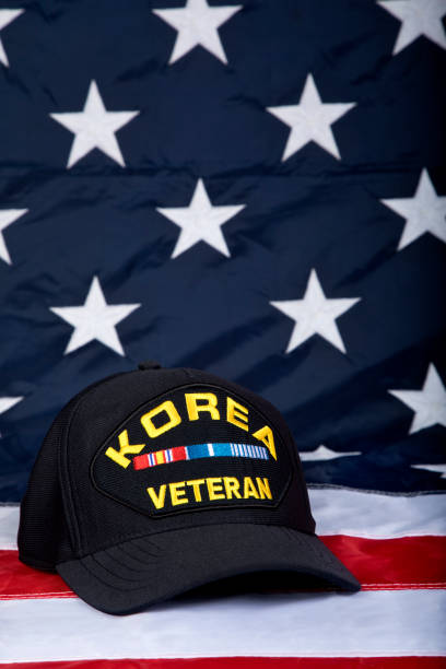 istock Korea Veterans cap close up with American Flag background 1330257191