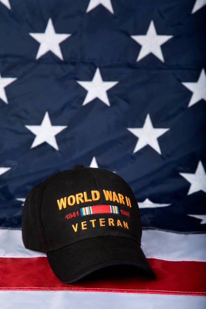 istock World War Two Veterans cap with American Flag background, vertical 1330257727