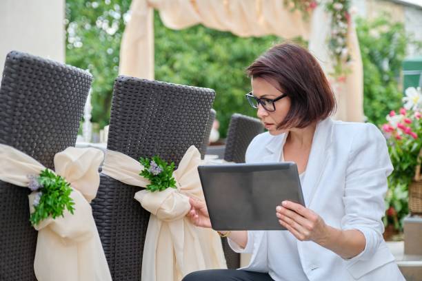 istock Woman professional decorator with digital tablet working outdoors decorating ceremony 1330258213