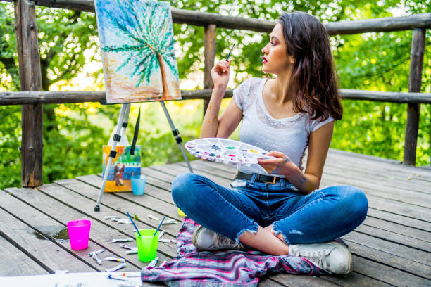 istock Young female artist painting 1330259014