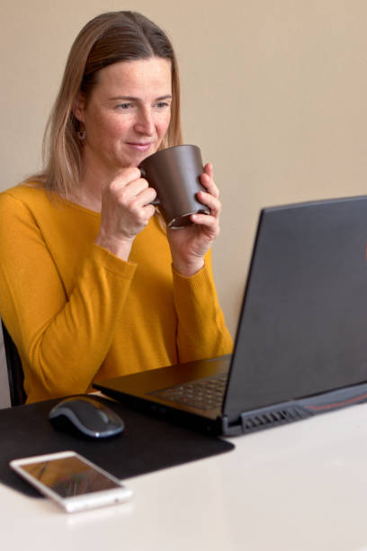 istock Woman having a coffee before while working from home 1330261152