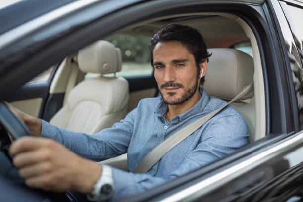 istock Young man in car 1330261820