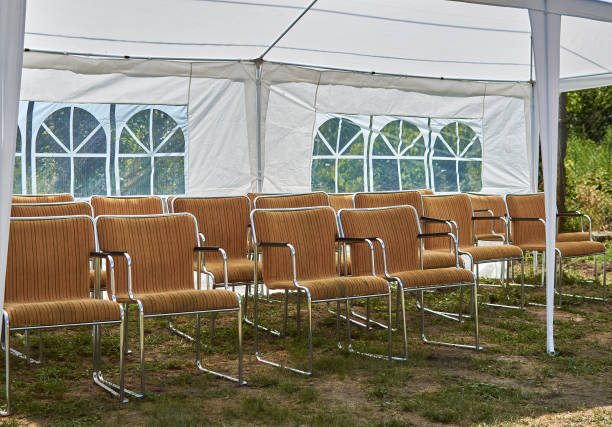 istock empty chairs under white party tent in the garden 1330262599