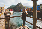 Tourist woman sightseeing Nyksund village in Norway travel lifestyle vacations outdoor scandinavian trip Vesteralen island