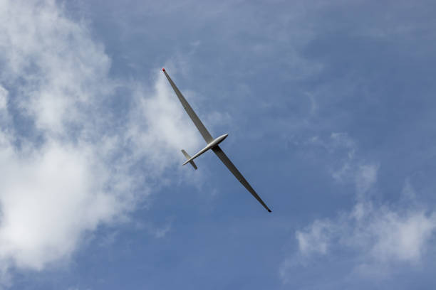 istock Glider against blue cloudy sky. Single seat high performance sailplane. 1330264930