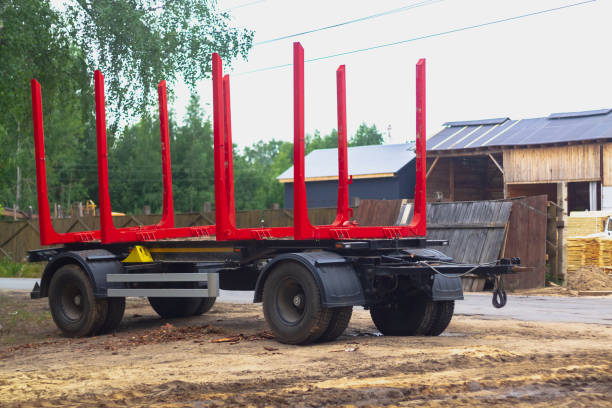 istock Trailer for transporting logs and planks with red fasteners and huge wheels 1330265809