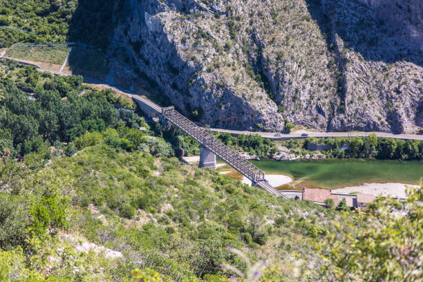 View of the Anduze railway bridge from the top of Rocher Saint-Julien (Occitanie, France) stock photo