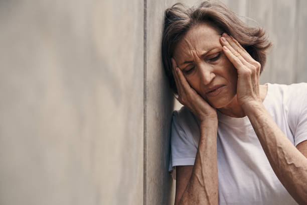 istock Seniour woman suffering from headache in open air 1330268862