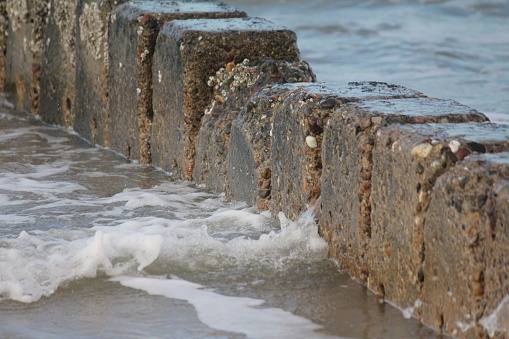 Stone breakwater on the North Sea beach
