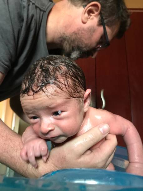 istock Close-up of newborn baby taking a bath. 1330274548