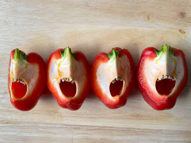 istock Sliced bell peppers on wooden cutting board seen from above 1330275610