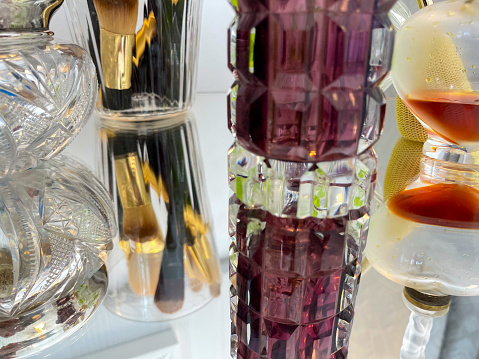 Perfumes reflected on mirror surface in the bathroom