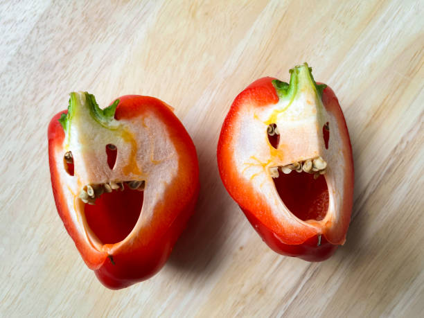 istock Sliced bell peppers on wooden cutting board seen from above 1330277676
